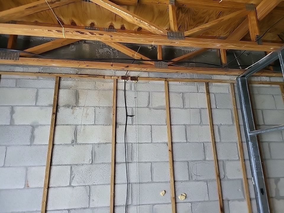 Block walls and wood framing exposed after fire damage demolition